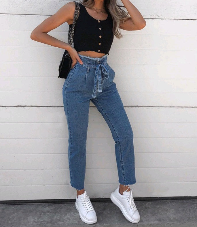 Front view of woman wearing blue high-waist stretch jeans 