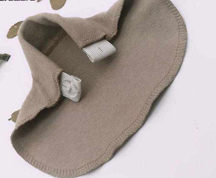 Close-u of beige no-sew pants waistband extender with button fastener