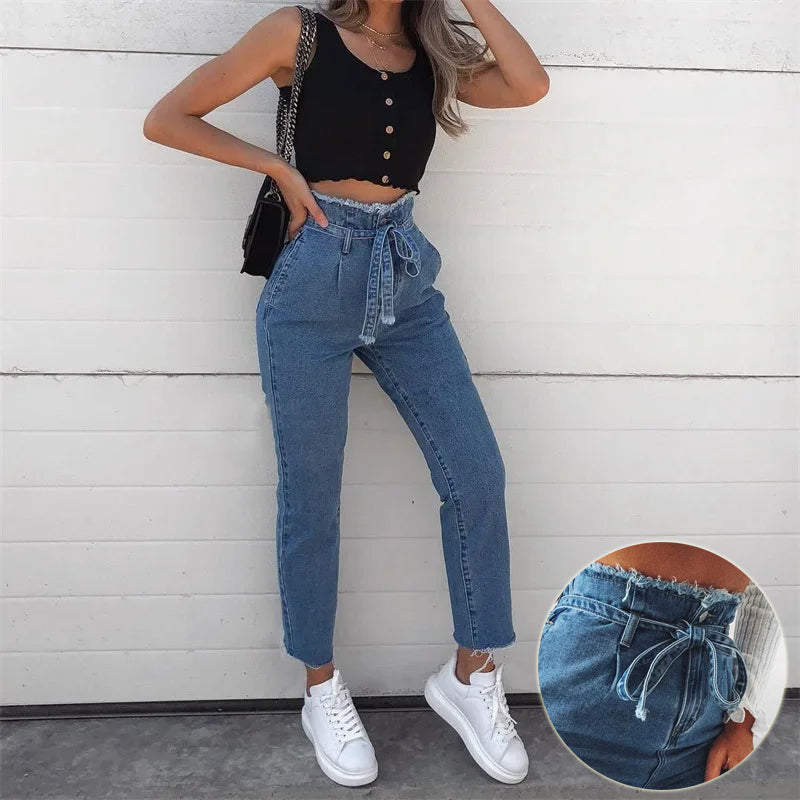 Woman wearing blue high-waist stretch jeans with tie-waist detail