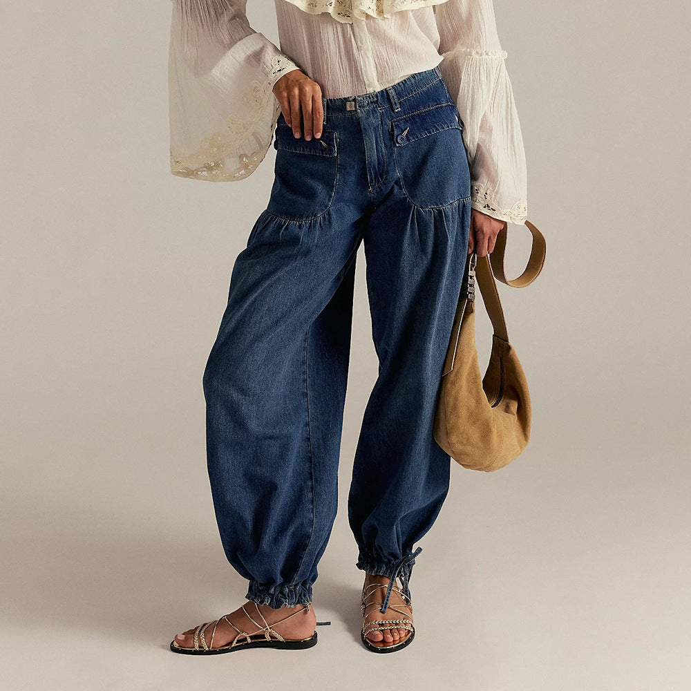 Woman wearing dark blue relaxed denim jeans with elastic cuffs