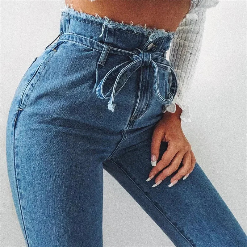 Close-up of blue high-waist stretch jeans with tie-waist detail